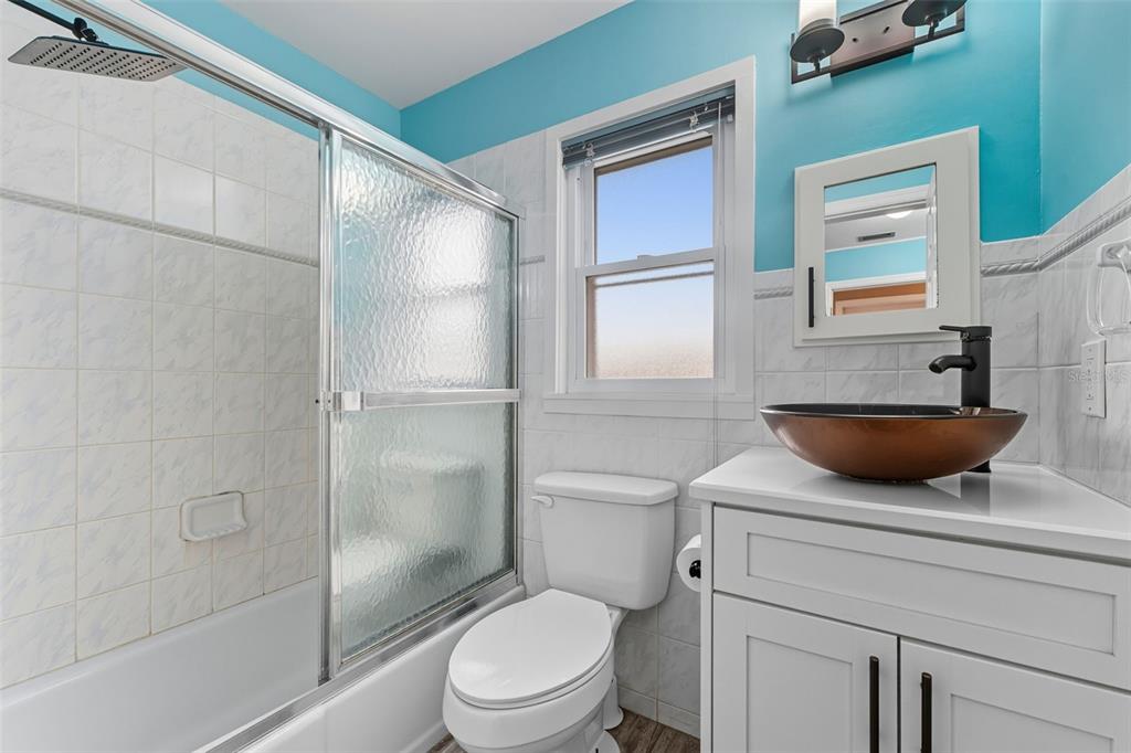 208 Bates Avenue Indian Rocks Beach, FL 33785 - Photo 27 of 47 a bathroom with a toilet a sink and shower