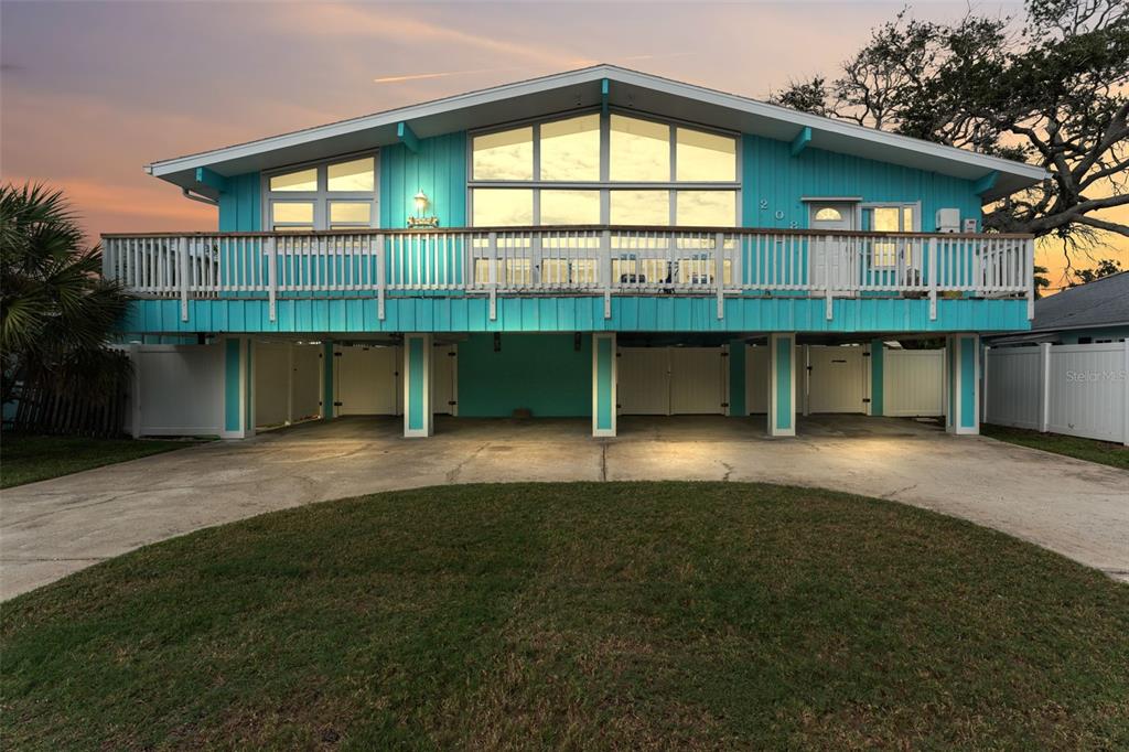 208 Bates Avenue Indian Rocks Beach, FL 33785 - Photo 3 of 47 a view of a backyard with a large tree