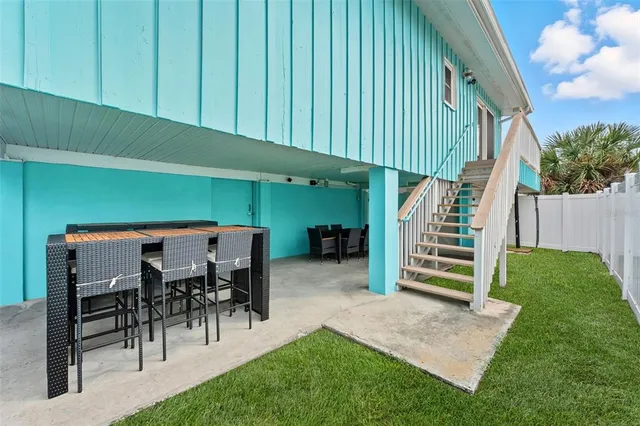 a backyard of a house with table and chairs