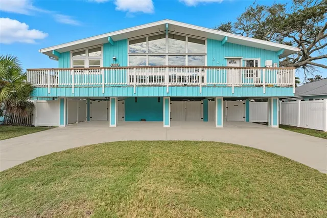 a view of a house with a backyard and a table and chairs