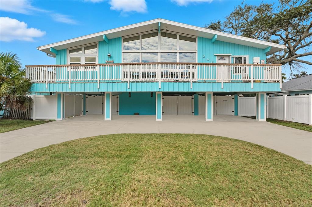208 Bates Avenue Indian Rocks Beach, FL 33785 - Photo 4 of 47 a view of a house with a backyard and a table and chairs