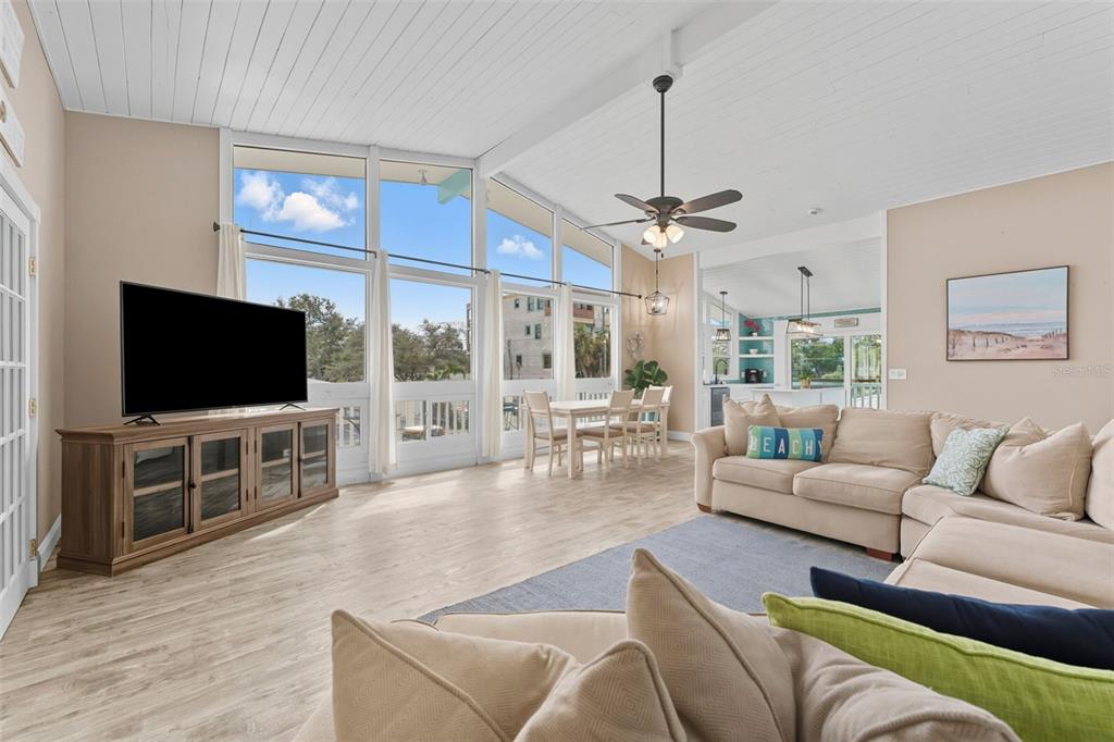 208 Bates Avenue Indian Rocks Beach, FL 33785 - Photo 10 of 47 a living room with furniture and a flat screen tv