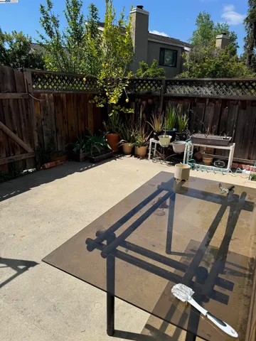 a view of backyard with wheel chair and potted plants