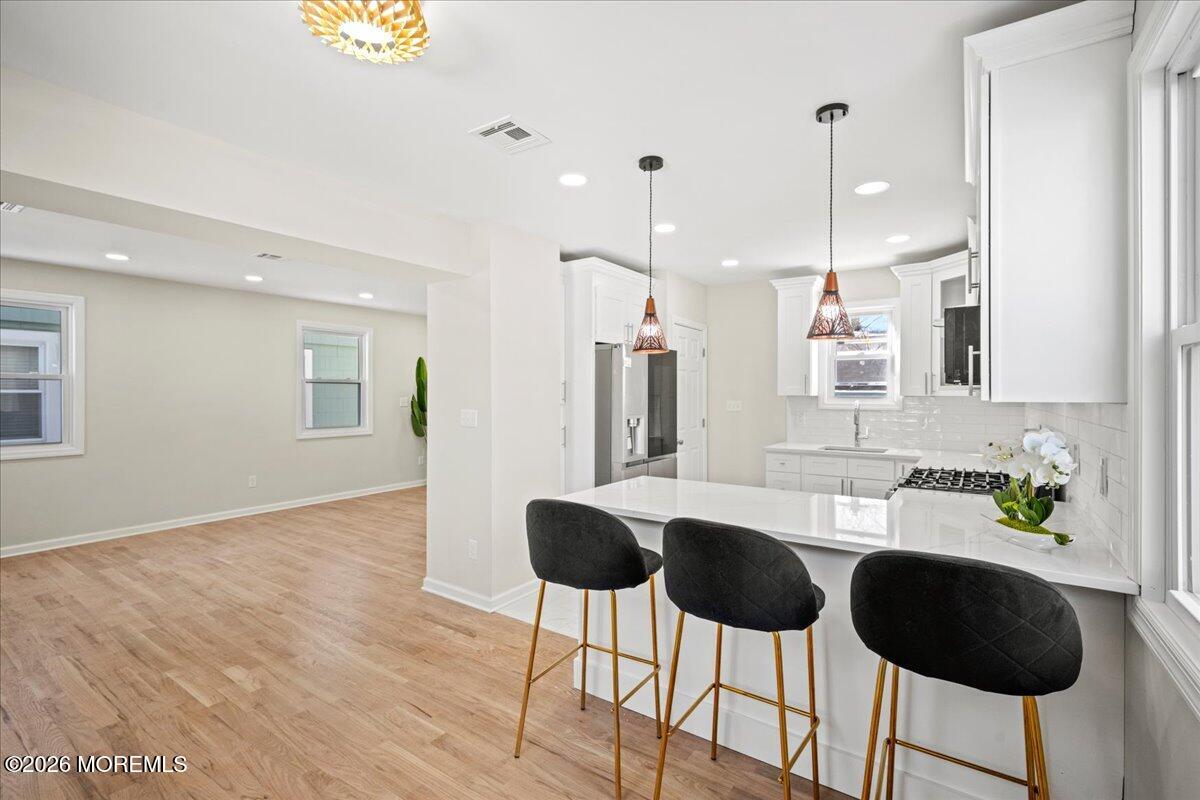 20 Elston Street Bloomfield, NJ 07003 - Photo 14 of 43 a kitchen with stainless steel appliances kitchen island granite countertop a table and chairs