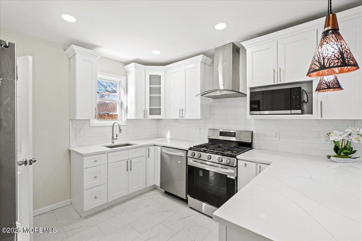 20 Elston Street Bloomfield, NJ 07003 - Photo 16 of 43 a kitchen with cabinets stainless steel appliances and wooden floor