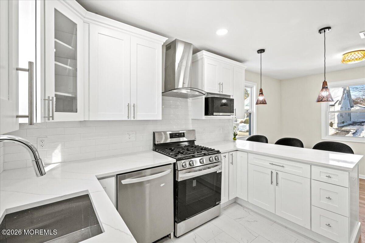 20 Elston Street Bloomfield, NJ 07003 - Photo 17 of 43 a kitchen with white cabinets and white appliances