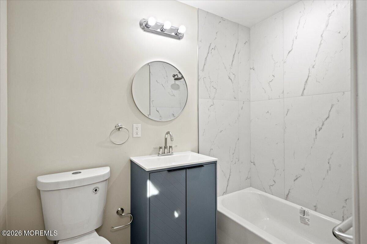 20 Elston Street Bloomfield, NJ 07003 - Photo 18 of 43 a bathroom with a sink a toilet and shower