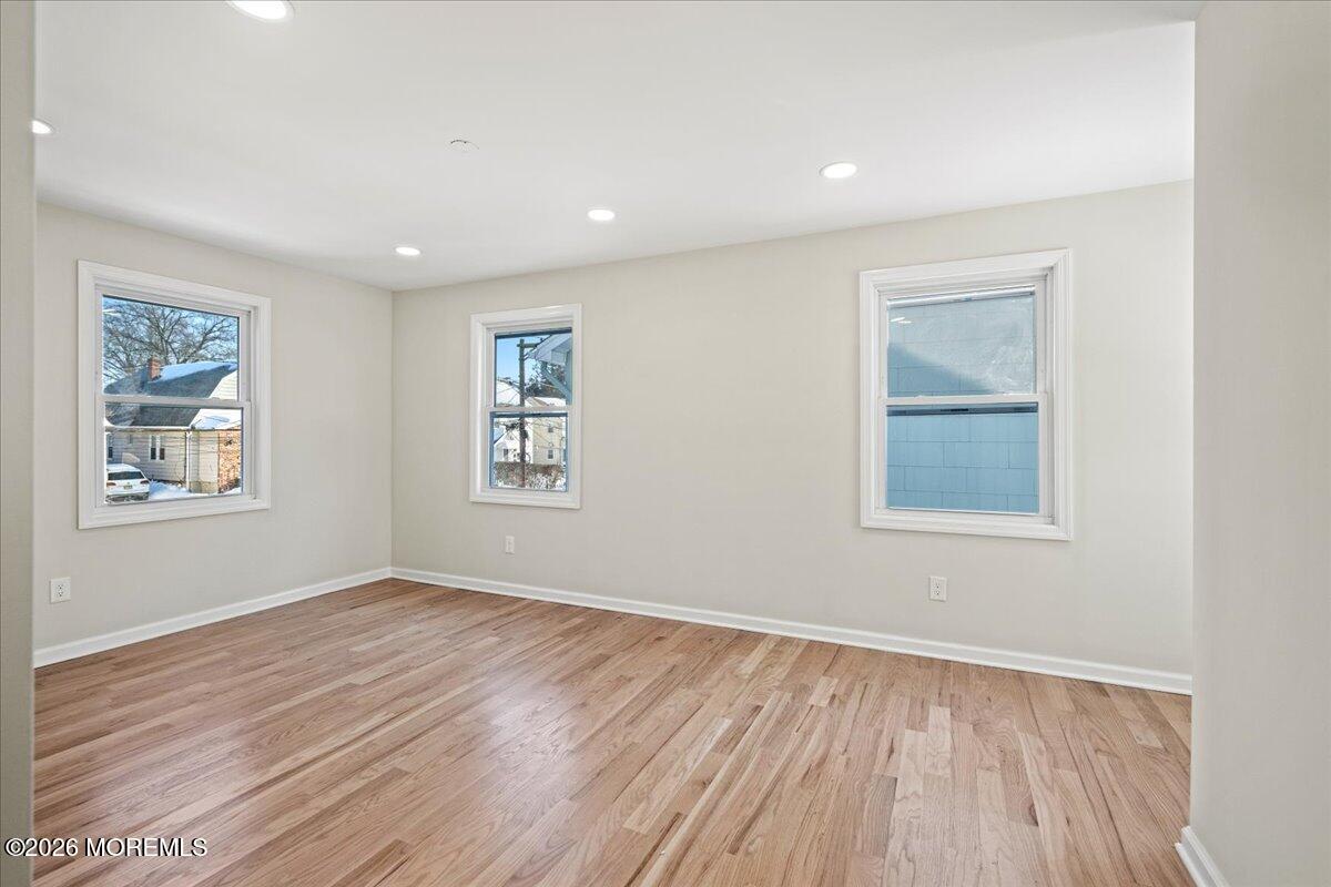 20 Elston Street Bloomfield, NJ 07003 - Photo 20 of 43 a view of an empty room with wooden floor and a window