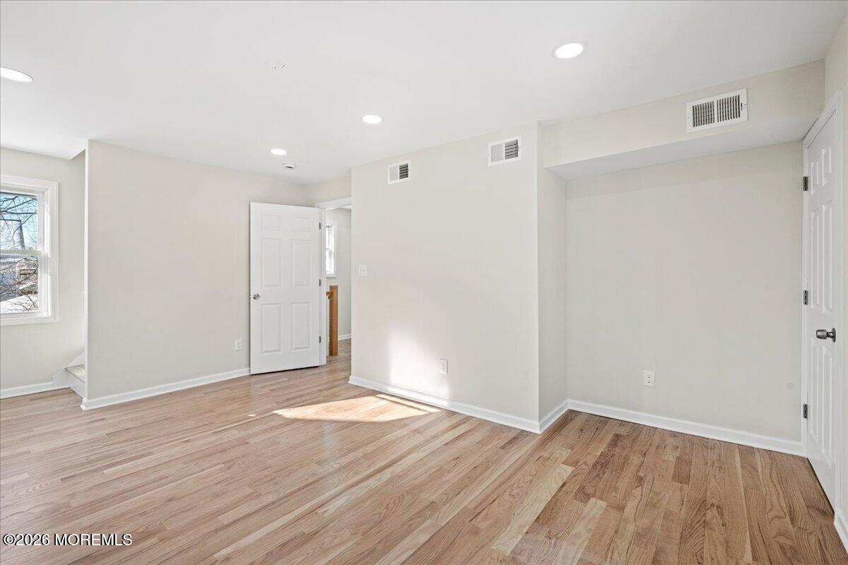 20 Elston Street Bloomfield, NJ 07003 - Photo 21 of 43 wooden floor in an empty room with a window