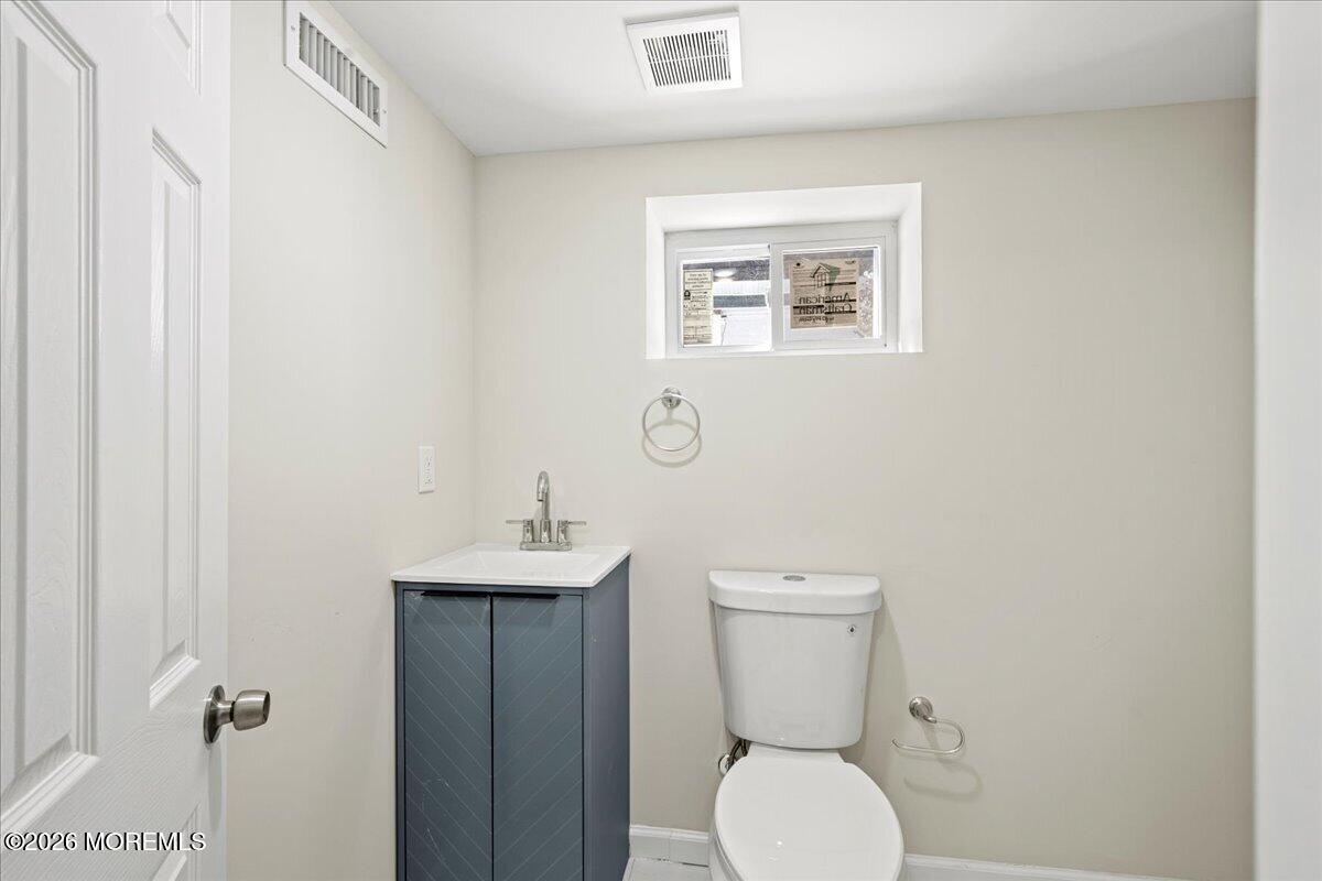20 Elston Street Bloomfield, NJ 07003 - Photo 41 of 43 a bathroom with a toilet a sink and mirror