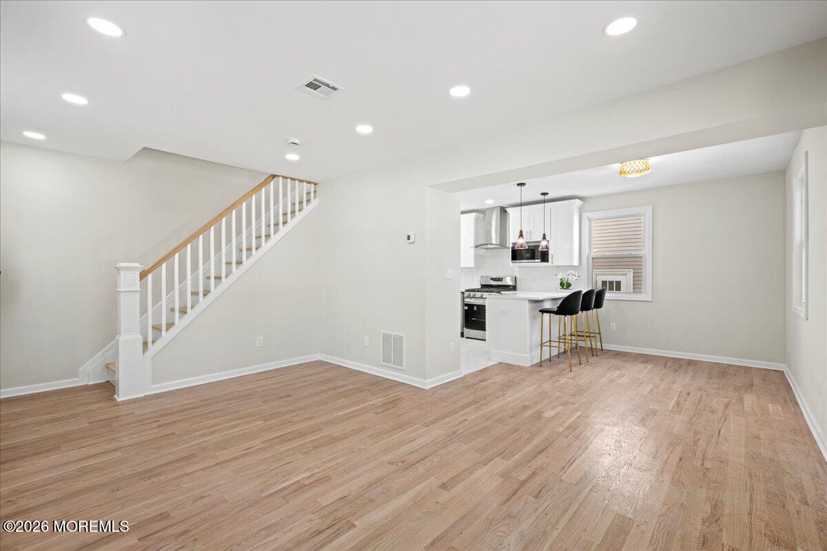 20 Elston Street Bloomfield, NJ 07003 - Photo 5 of 43 a view of empty room with wooden floor