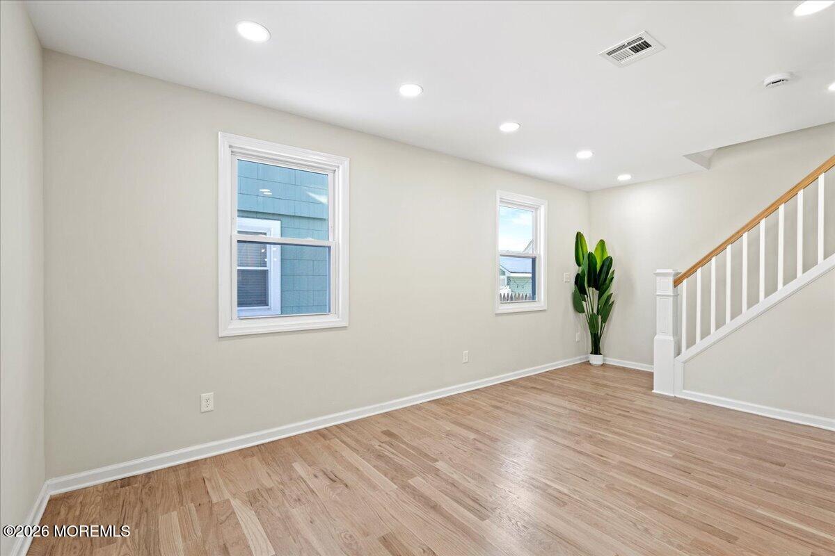20 Elston Street Bloomfield, NJ 07003 - Photo 7 of 43 a view of an empty room with wooden floor and a window