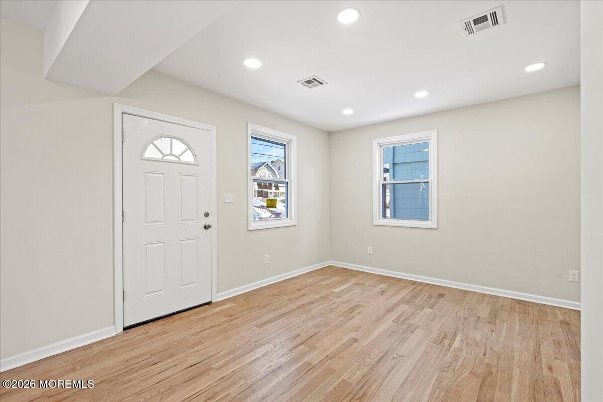 20 Elston Street Bloomfield, NJ 07003 - Photo 10 of 43 wooden floor in an empty room with a window