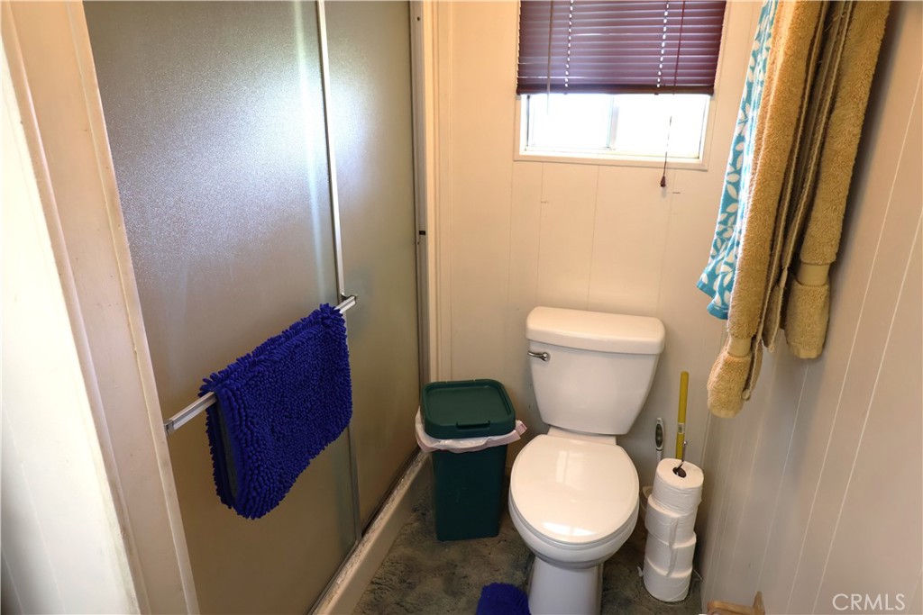 22189 Samson Avenue Corning, CA 96021 - Photo 20 of 59 a bathroom with a toilet and a shower curtain