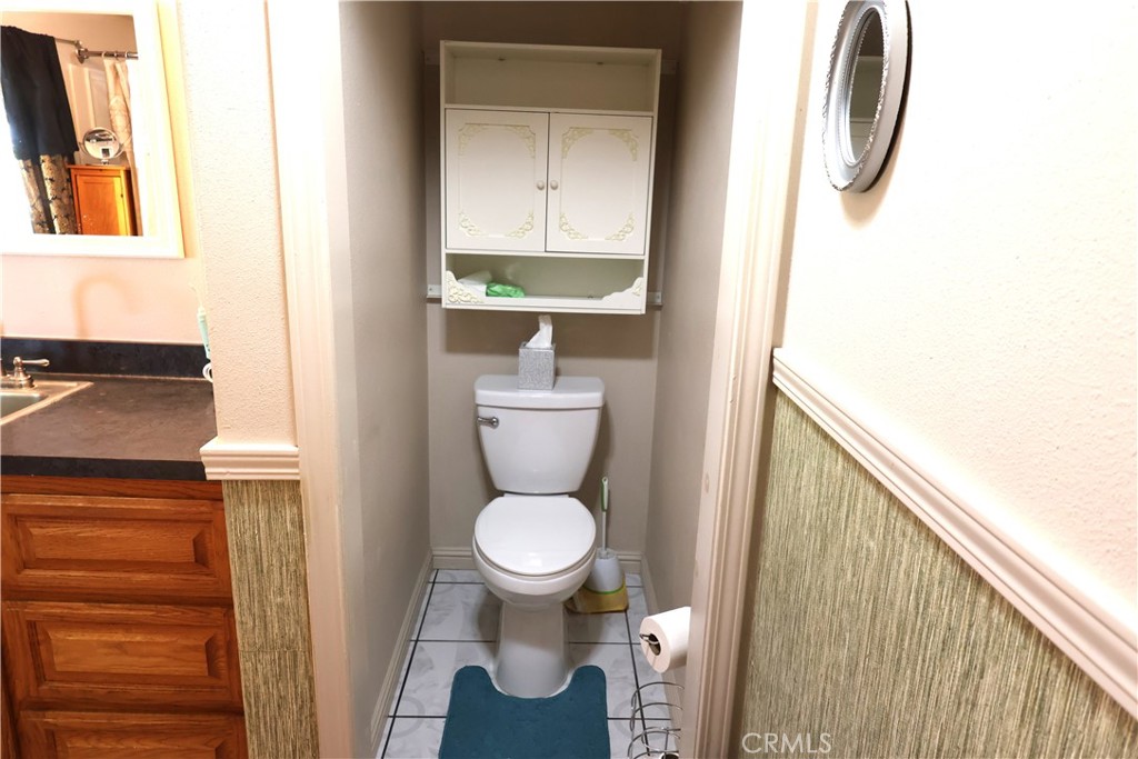 22189 Samson Avenue Corning, CA 96021 - Photo 25 of 59 a bathroom with a toilet and a sink