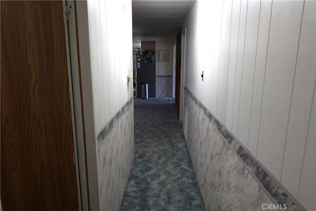 22189 Samson Avenue Corning, CA 96021 - Photo 29 of 59 a view of a hallway with a wooden door