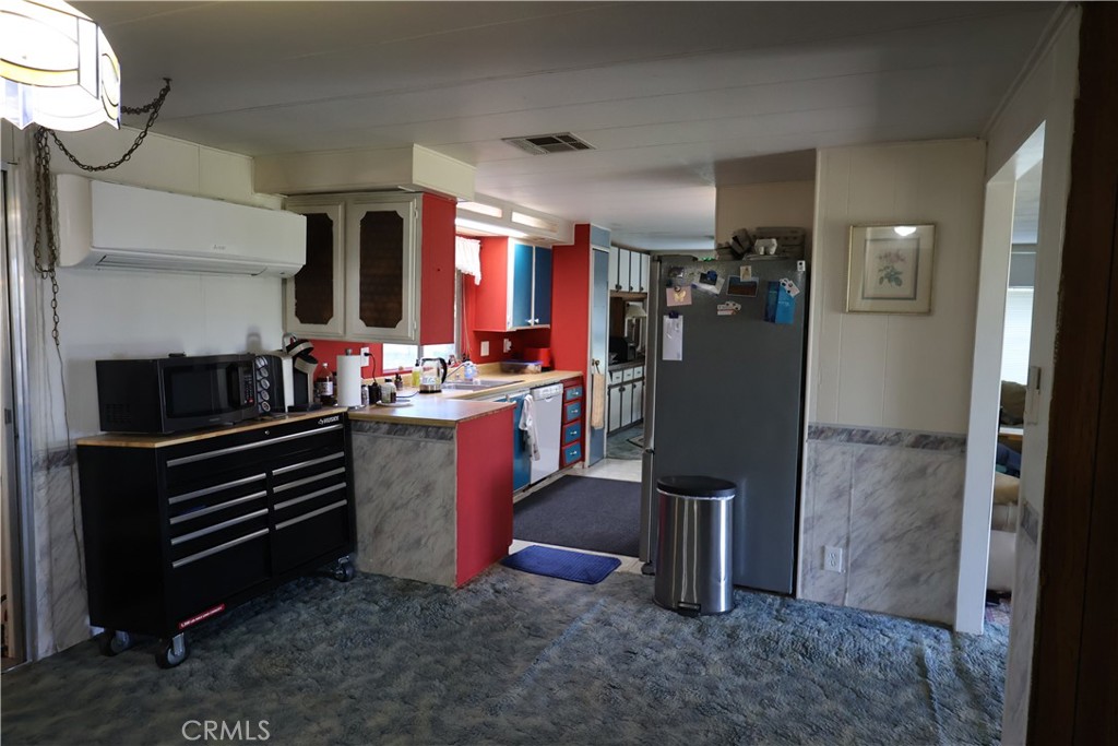22189 Samson Avenue Corning, CA 96021 - Photo 30 of 59 a kitchen with refrigerator and cabinets