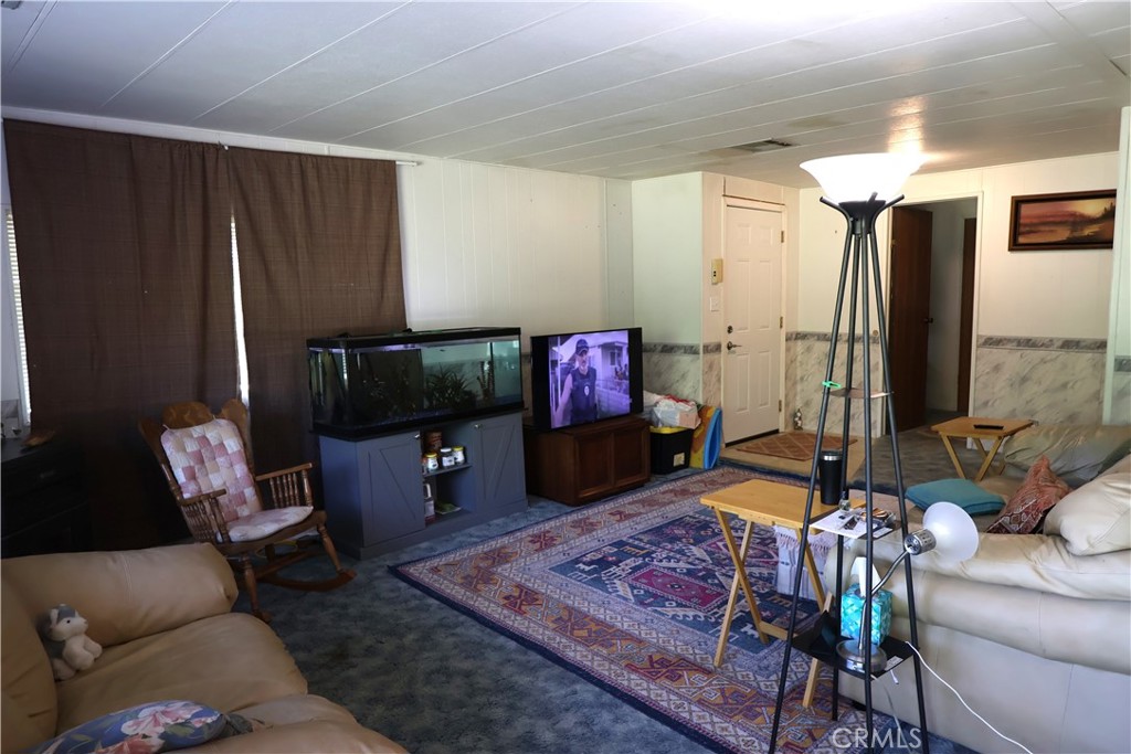 22189 Samson Avenue Corning, CA 96021 - Photo 6 of 59 a living room with furniture and a flat screen tv