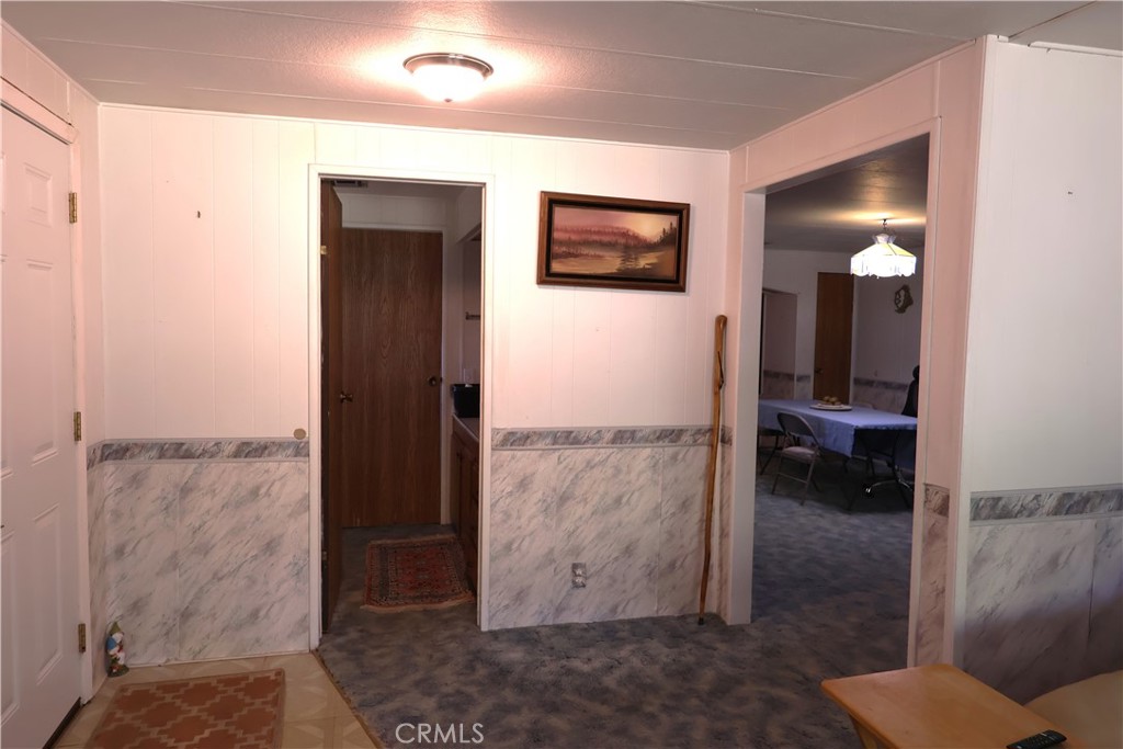 22189 Samson Avenue Corning, CA 96021 - Photo 8 of 59 a view of a hallway with paintings on the wall