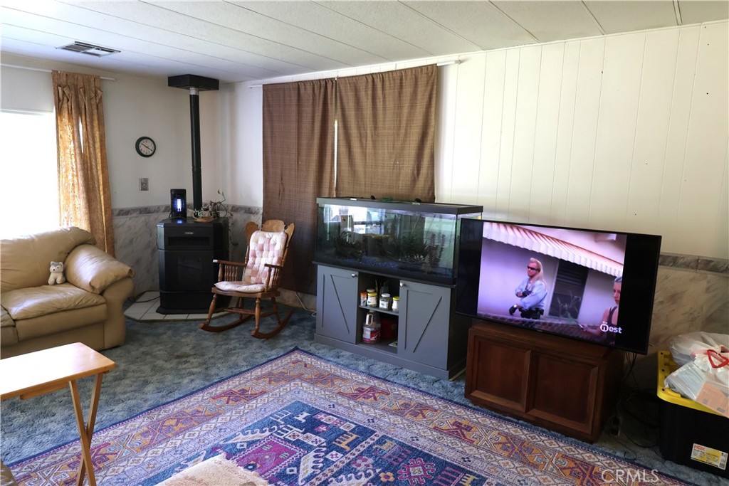 22189 Samson Avenue Corning, CA 96021 - Photo 9 of 59 a living room with furniture a rug and a fireplace