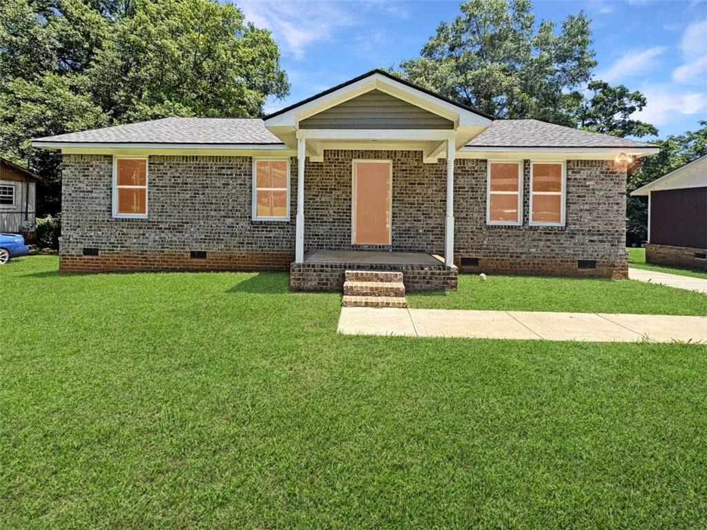 24 George Street Forsyth, GA 31029 - Photo 1 of 17 a front view of a house with a yard
