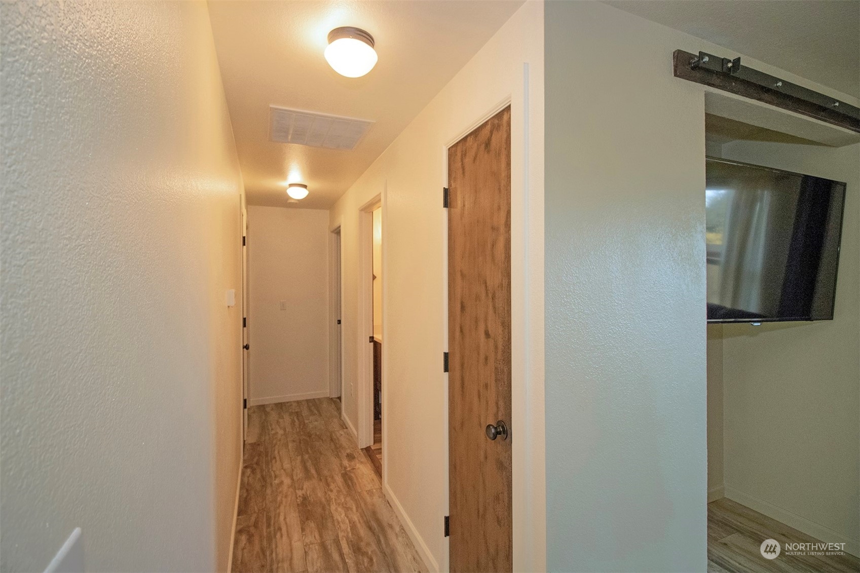 17836 Camus Drive Southwest Rochester, WA 98579 - Photo 12 of 27 a view of a hallway with wooden floor