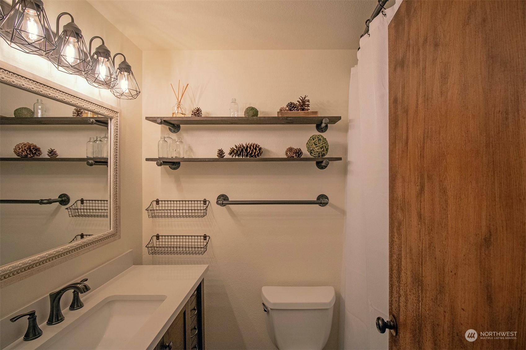 17836 Camus Drive Southwest Rochester, WA 98579 - Photo 13 of 27 a bathroom with a sink a toilet and shower curtain