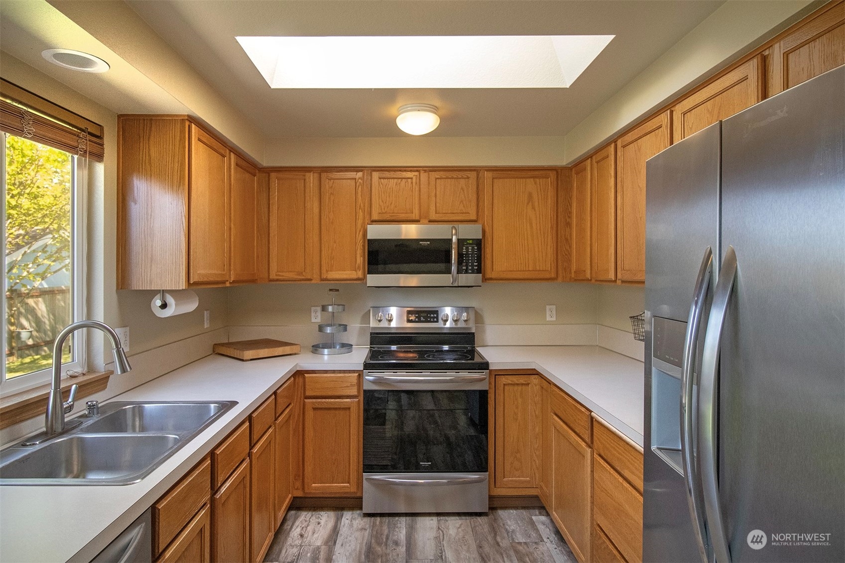 17836 Camus Drive Southwest Rochester, WA 98579 - Photo 10 of 27 a kitchen with a refrigerator a sink and cabinets