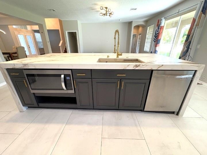 1431 Spring Fest Lane Orlando, FL 32828 - Photo 11 of 36 a bathroom with a sink vanity and a mirror