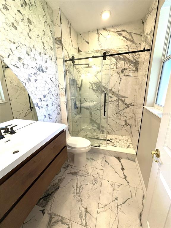 1431 Spring Fest Lane Orlando, FL 32828 - Photo 13 of 36 a bathroom with a sink toilet and shower