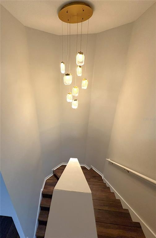 1431 Spring Fest Lane Orlando, FL 32828 - Photo 15 of 36 a bedroom with a bed and a chandelier