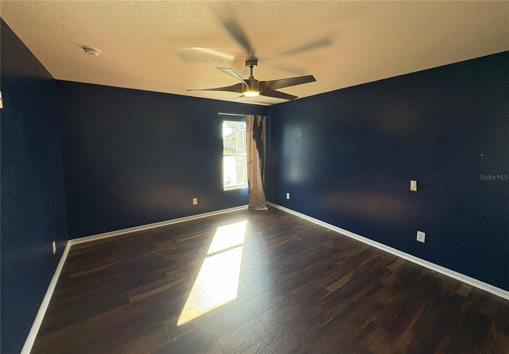 1431 Spring Fest Lane Orlando, FL 32828 - Photo 18 of 36 wooden floor in an empty room with a window