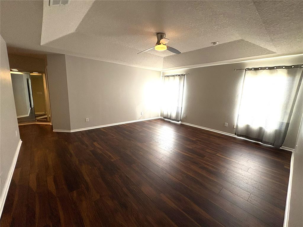 1431 Spring Fest Lane Orlando, FL 32828 - Photo 24 of 36 an empty room with wooden floor and windows