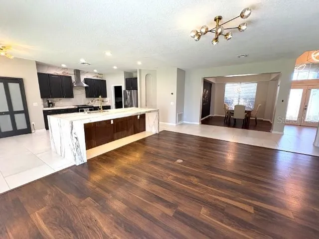 a view of a living room kitchen and a flat screen tv