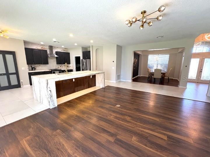 1431 Spring Fest Lane Orlando, FL 32828 - Photo 3 of 36 a view of a living room kitchen and a flat screen tv