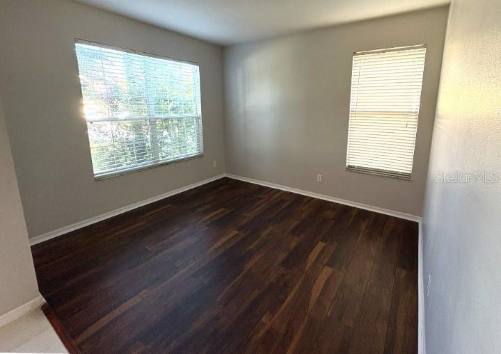 1431 Spring Fest Lane Orlando, FL 32828 - Photo 8 of 36 a view of an empty room with wooden floor and a window