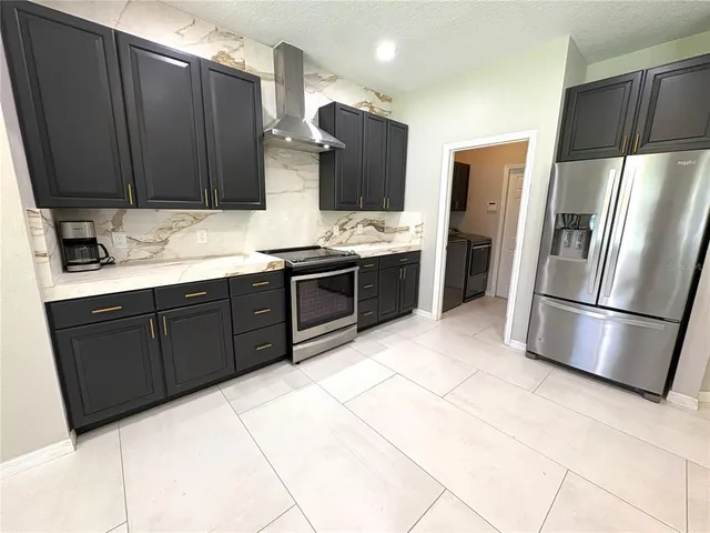 a kitchen with stainless steel appliances a refrigerator and a sink