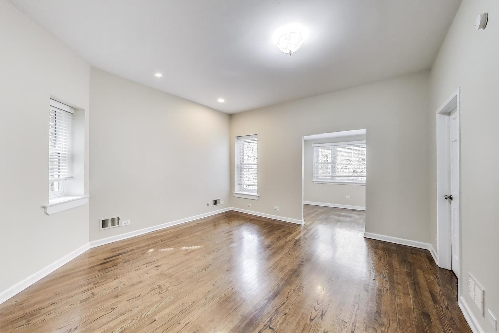 636 West Grace Street, Unit 2W Chicago, IL 60613 - Photo 13 of 26 an empty room with wooden floor and windows