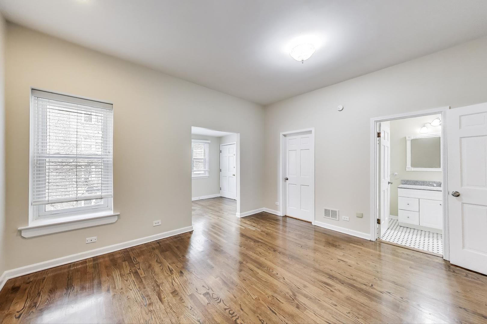 636 West Grace Street, Unit 2W Chicago, IL 60613 - Photo 14 of 26 an empty room with wooden floor and windows