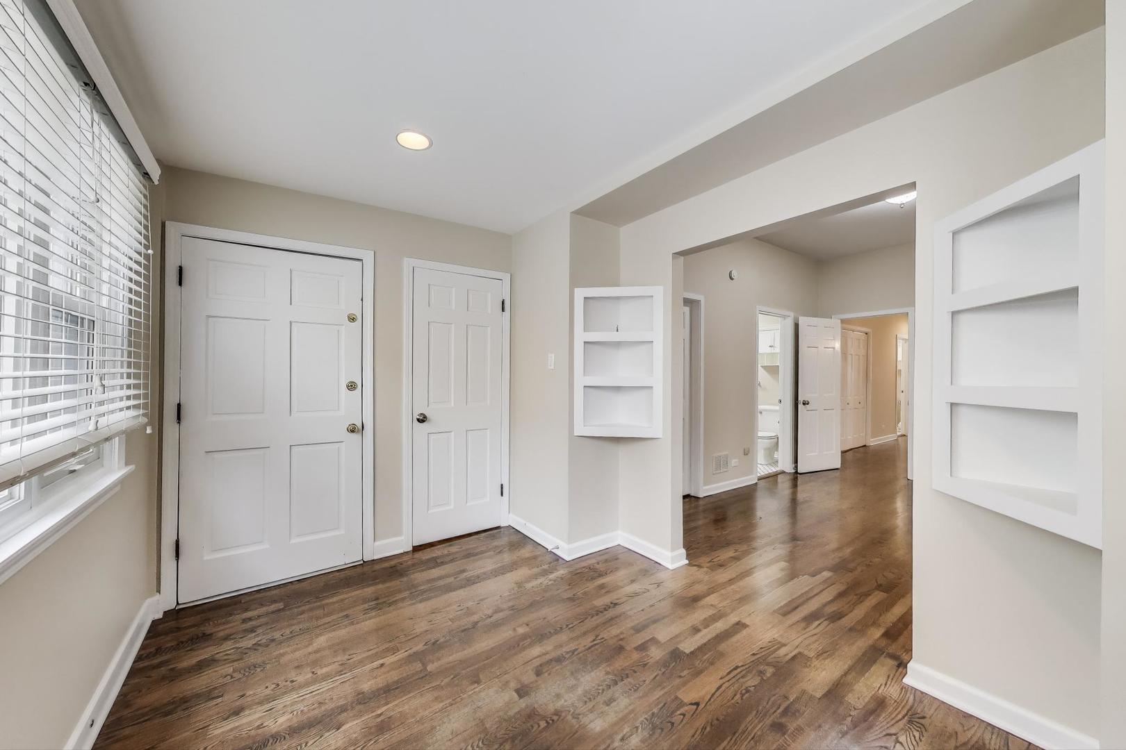 636 West Grace Street, Unit 2W Chicago, IL 60613 - Photo 17 of 26 a view of empty room with wooden floor and entryway
