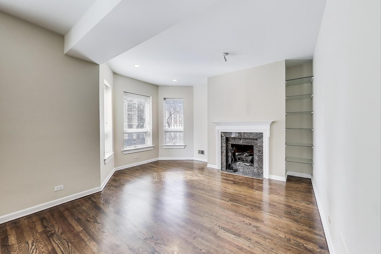 636 West Grace Street, Unit 2W Chicago, IL 60613 - Photo 2 of 26 a view of an empty room with a window and fireplace