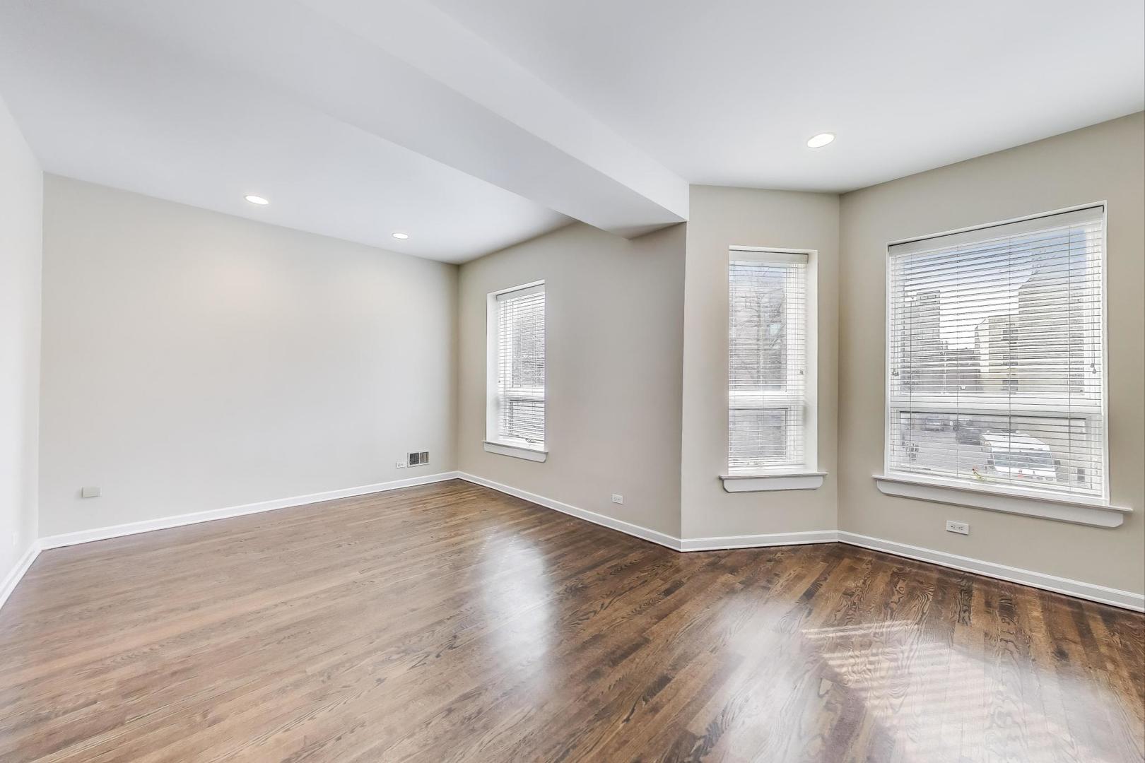 636 West Grace Street, Unit 2W Chicago, IL 60613 - Photo 3 of 26 a view of empty room with wooden floor and fan