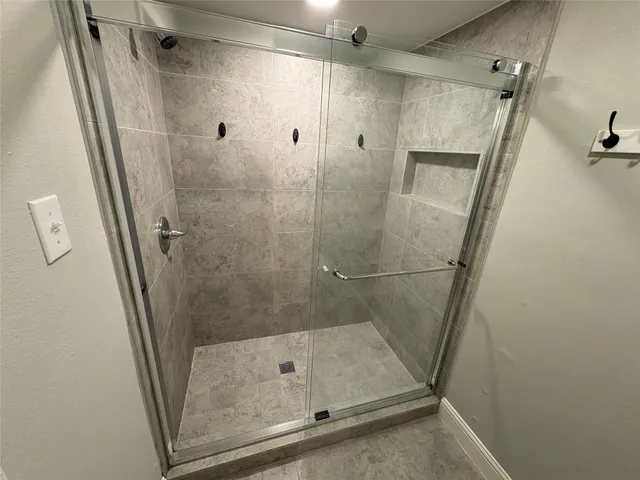 a bathroom with a glass door shower