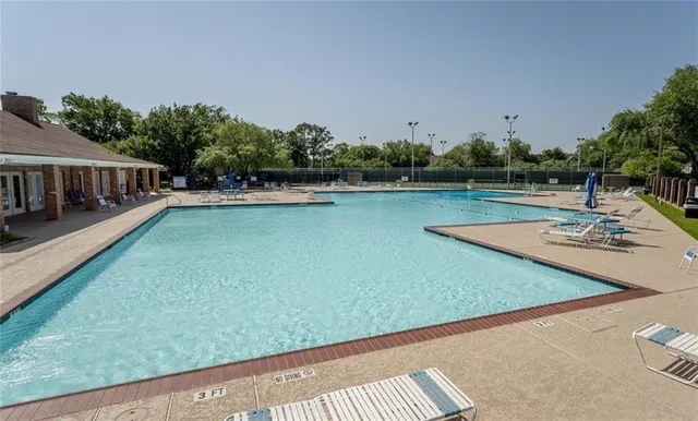 a view of a swimming pool with a yard