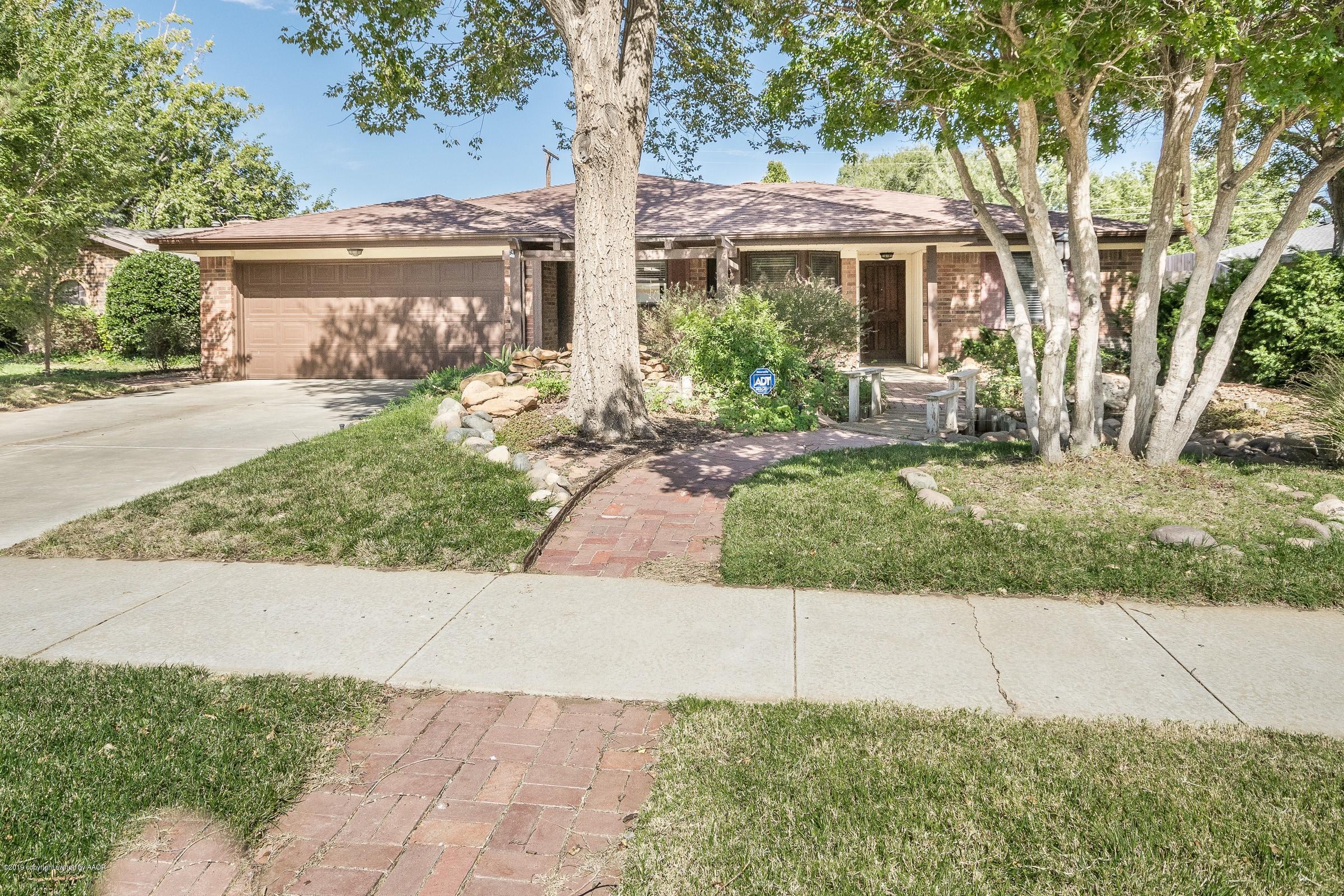 5610 Southwest 41st Avenue Amarillo, TX 79109 - Photo 1 of 30 a front view of a house with garden