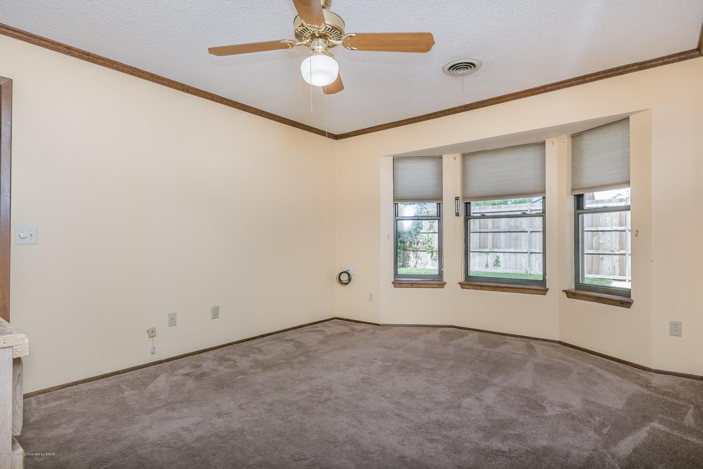 5610 Southwest 41st Avenue Amarillo, TX 79109 - Photo 21 of 30 an empty room with windows and fan