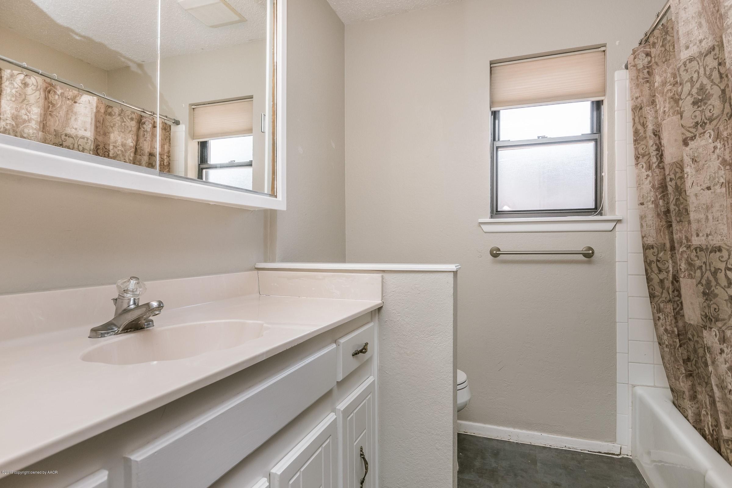5610 Southwest 41st Avenue Amarillo, TX 79109 - Photo 26 of 30 a bathroom with a sink and a window