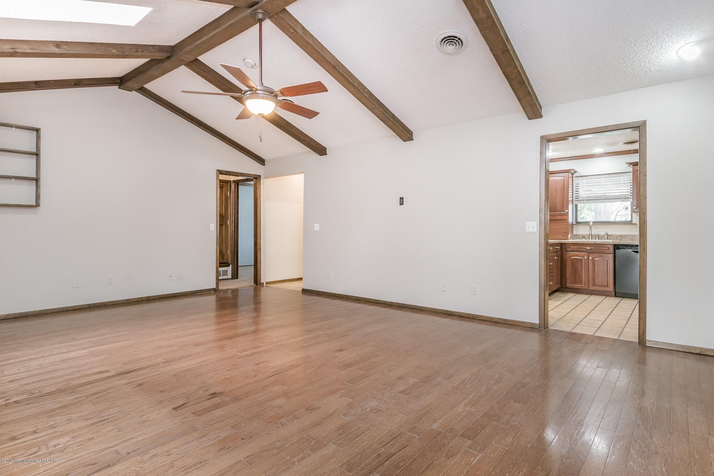 5610 Southwest 41st Avenue Amarillo, TX 79109 - Photo 9 of 30 a view of a livingroom with wooden floor and stairs