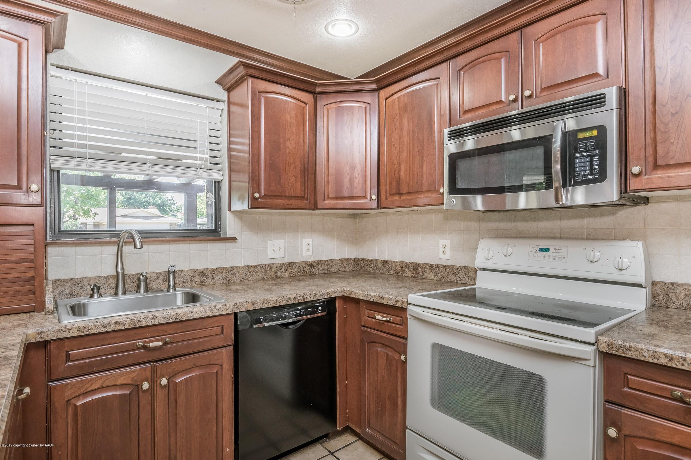 5610 Southwest 41st Avenue Amarillo, TX 79109 - Photo 10 of 30 a kitchen with granite countertop cabinets stainless steel appliances and a sink