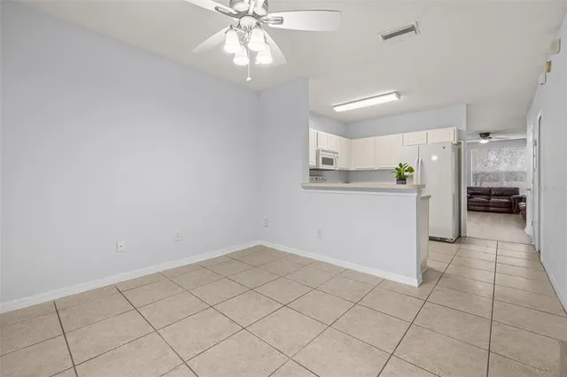 a view of a kitchen with white cabinets